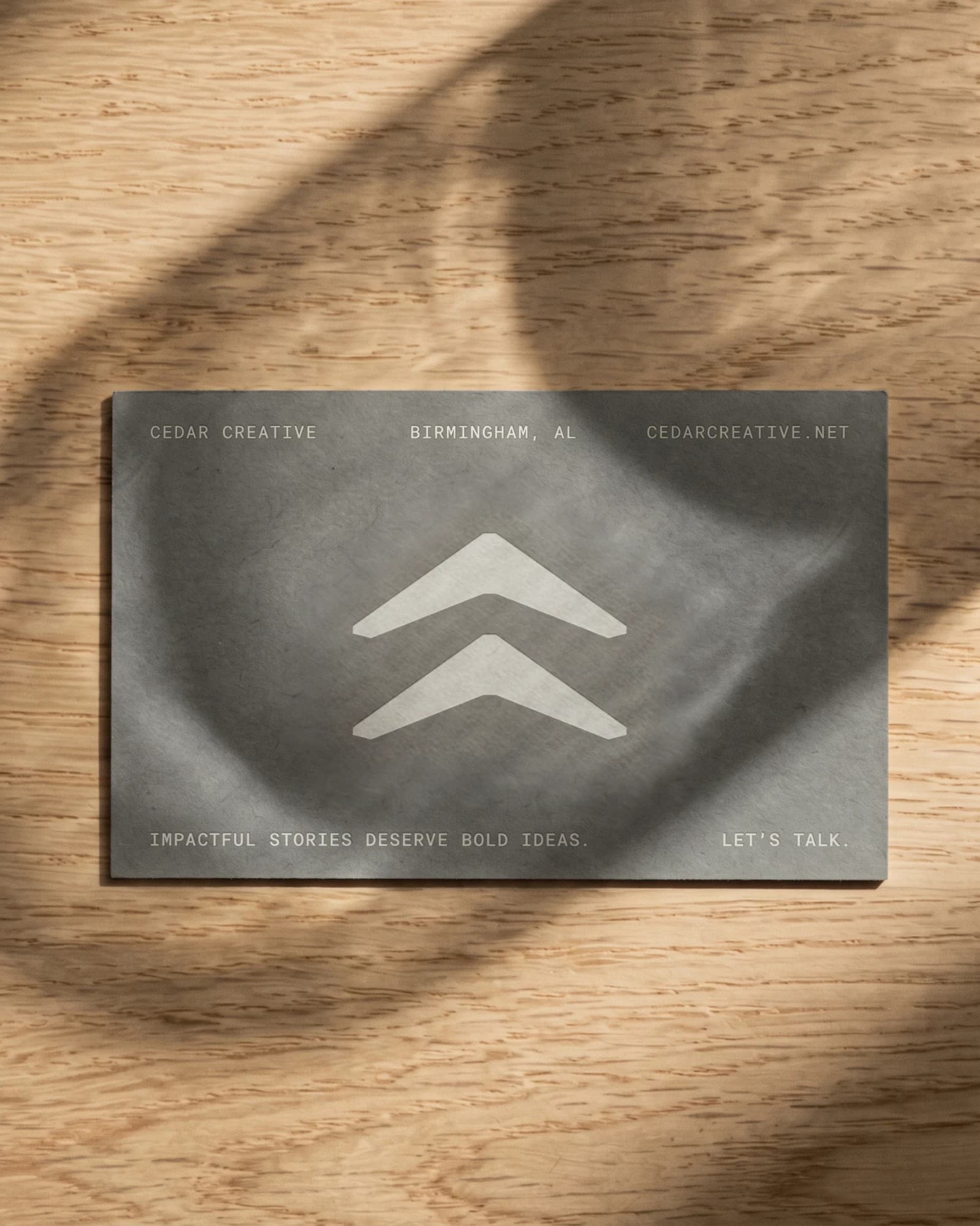 Cedar Creative business card on a wooden table